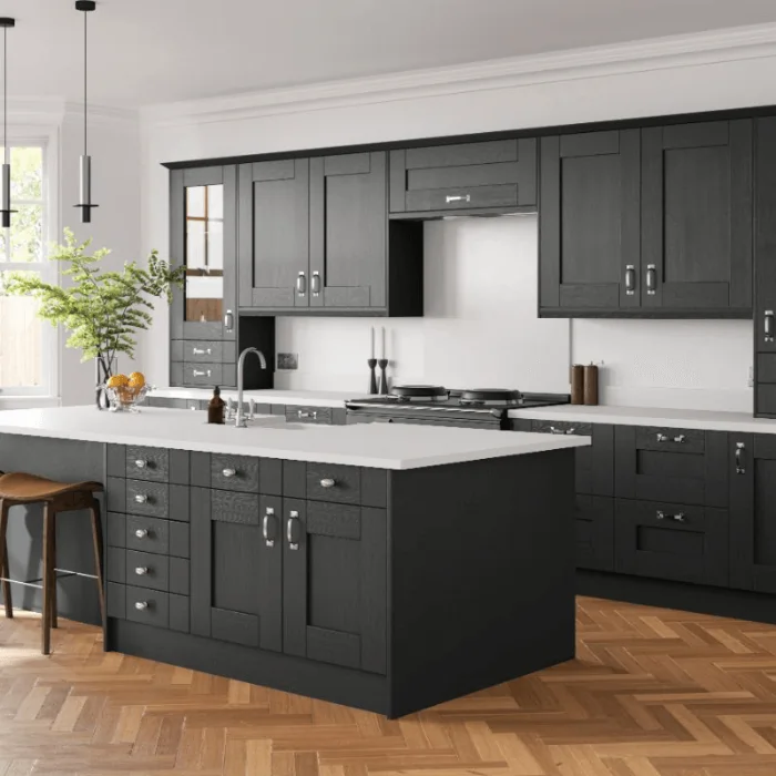 Open plan kitchen with black units and white worktops